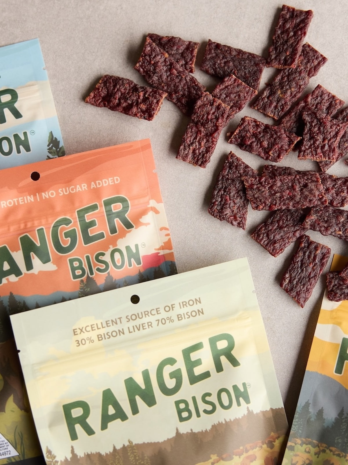 Ranger Bison snack packages with bison jerky on a neutral background
